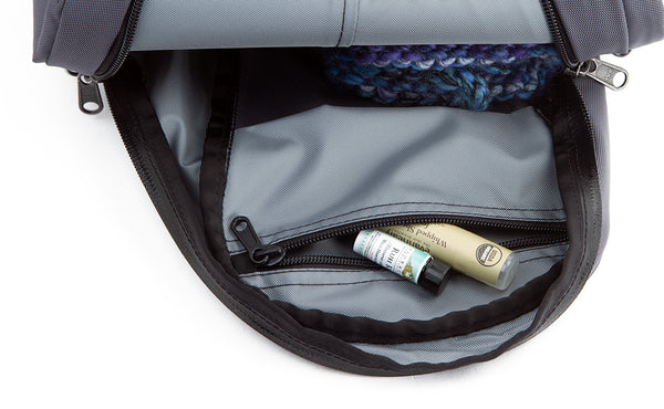 A chapstick and vial of perfume in the top interior zippered pocket.